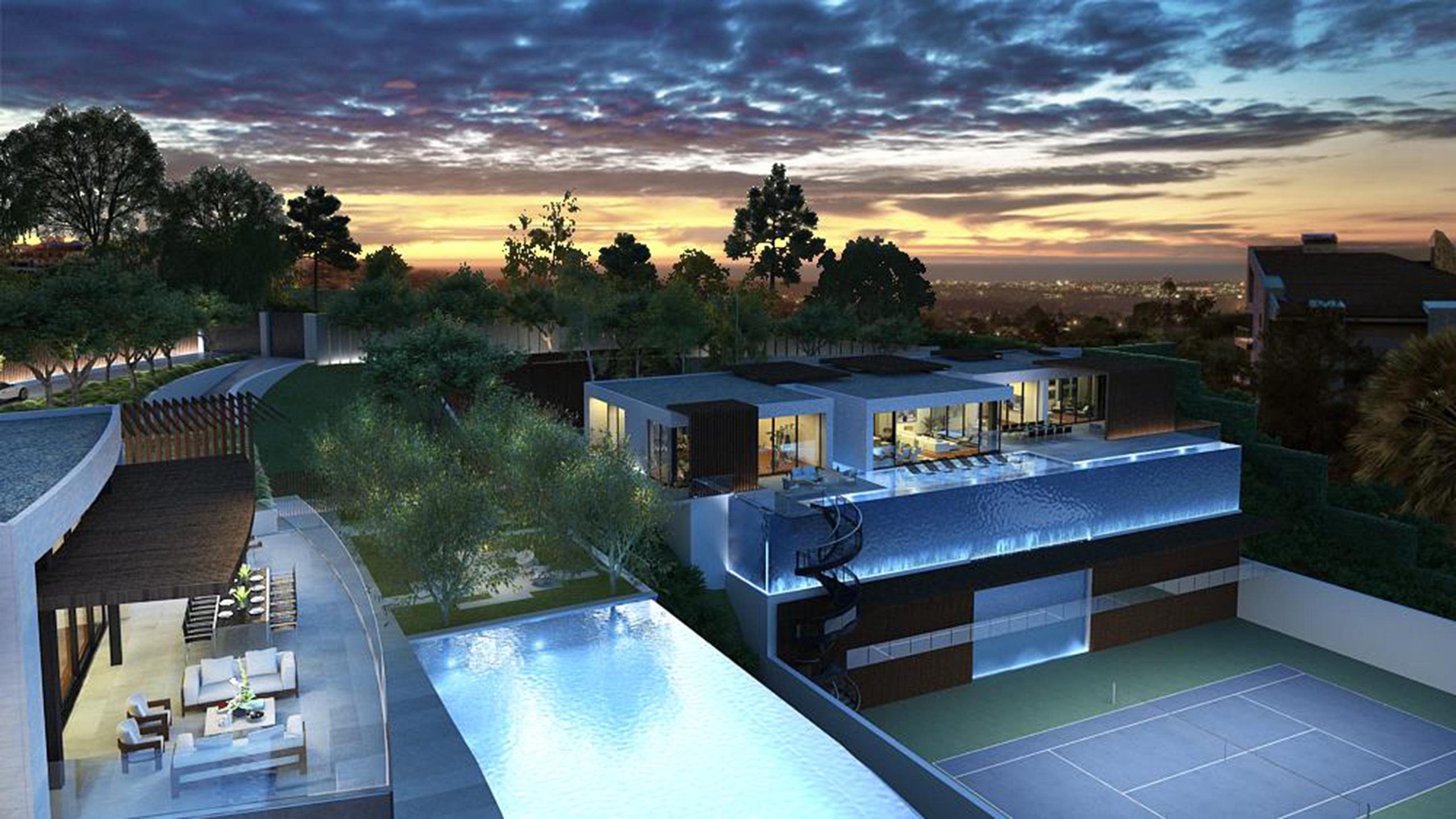 Bel Aire – Tione — Aerial dusk view of the full estate with curved pool edge and city lights beyond