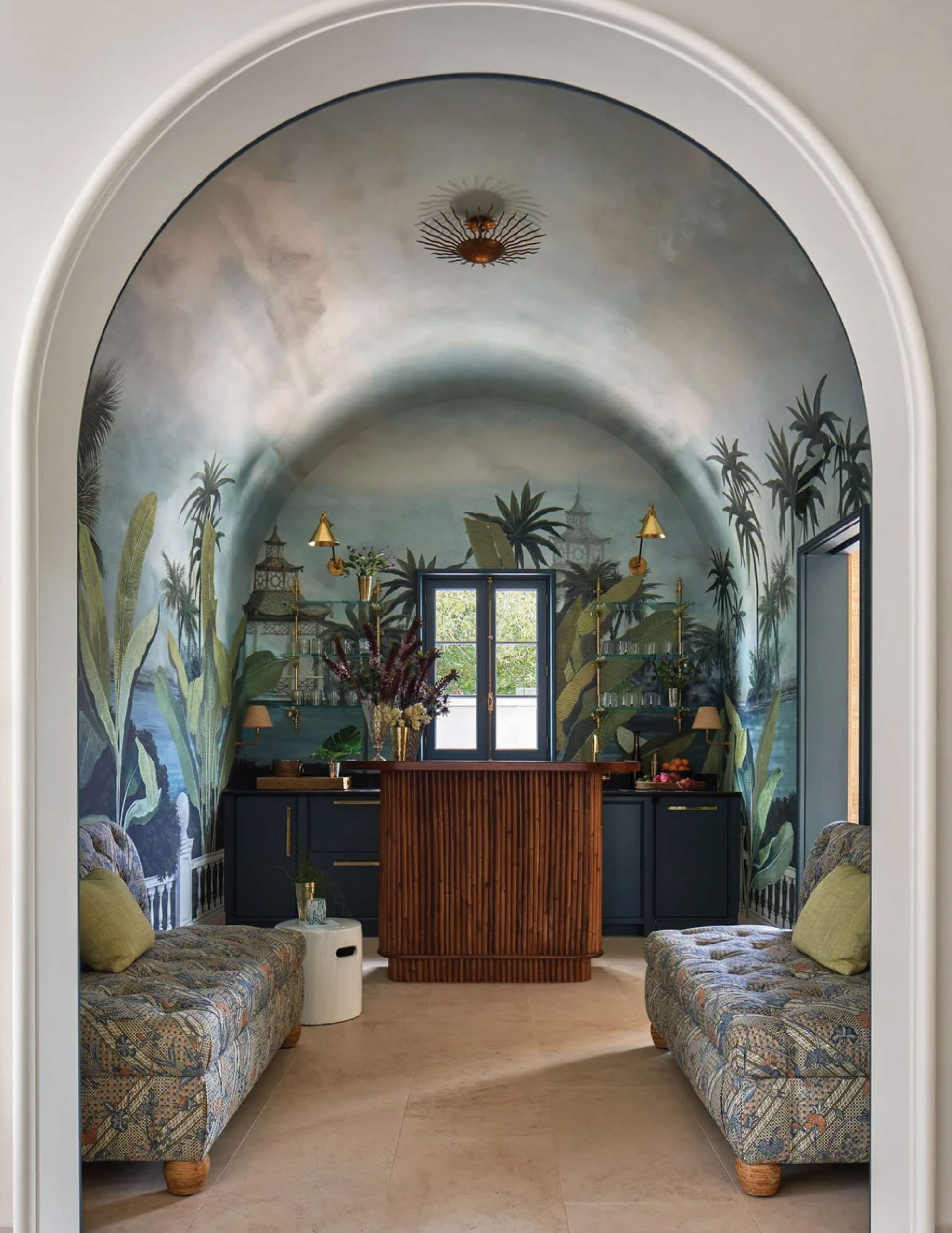 Park Cities – Crescent — Tropical-muraled bar room with bamboo-front counter viewed through arched opening