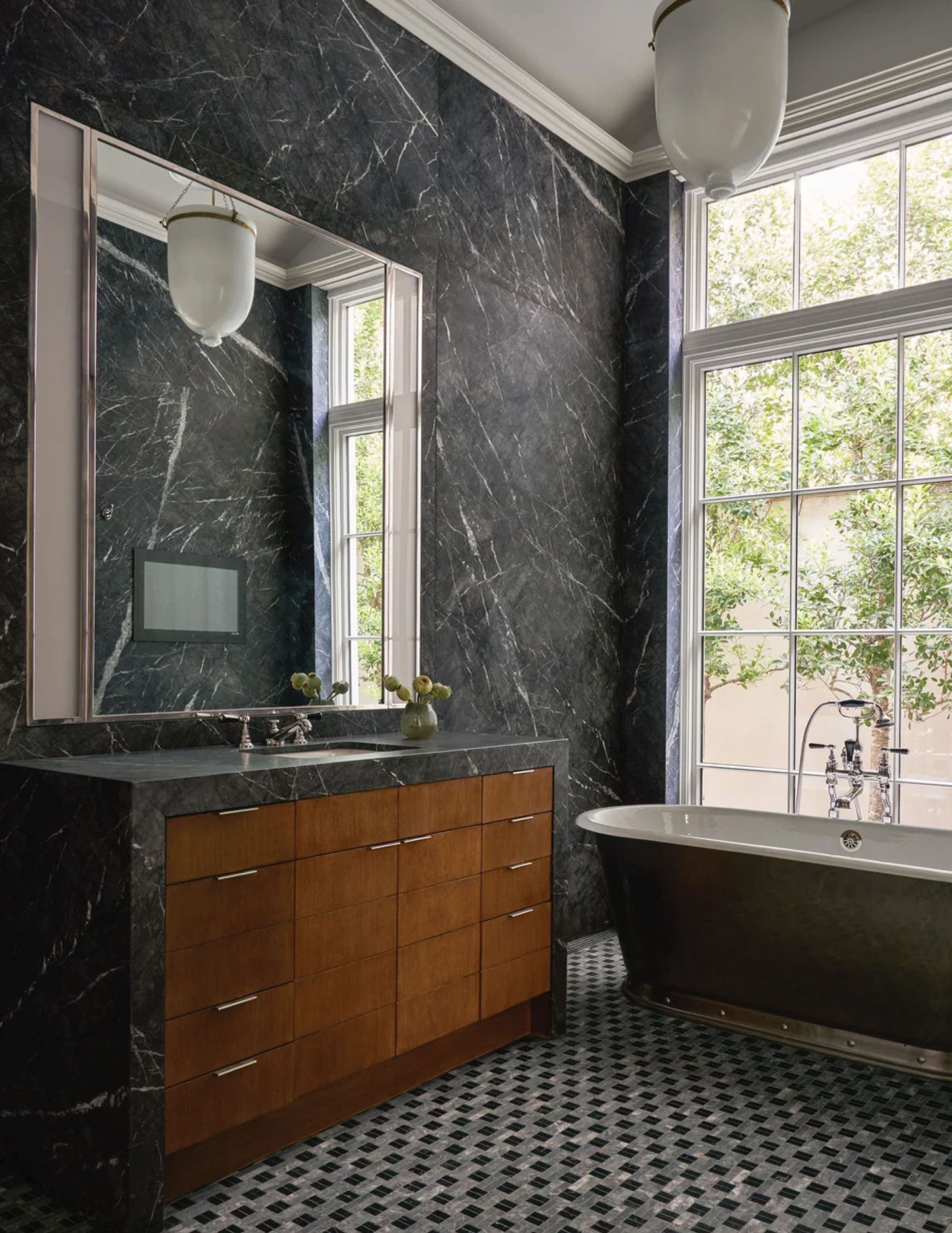 Park Cities – Crescent — Dark veined marble bathroom with bronze tub and picture window framing garden