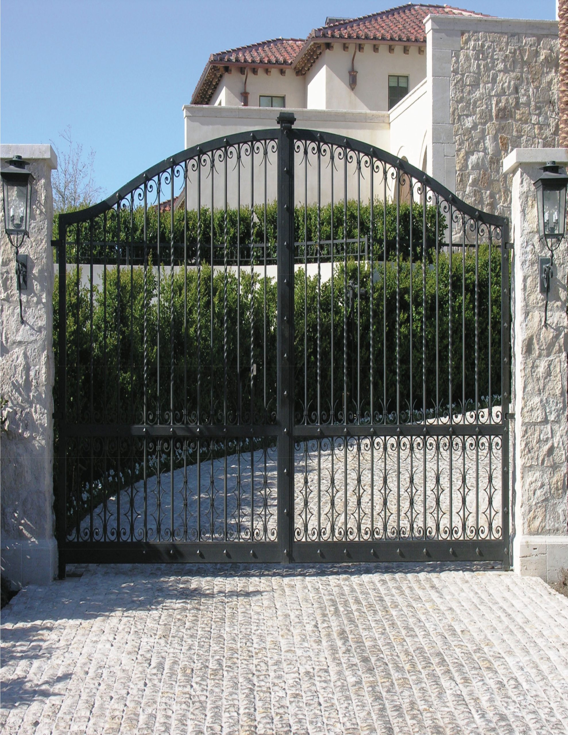 Las Vegas – Lot 8 — Arched stone gate with ornate carved detail at estate entry